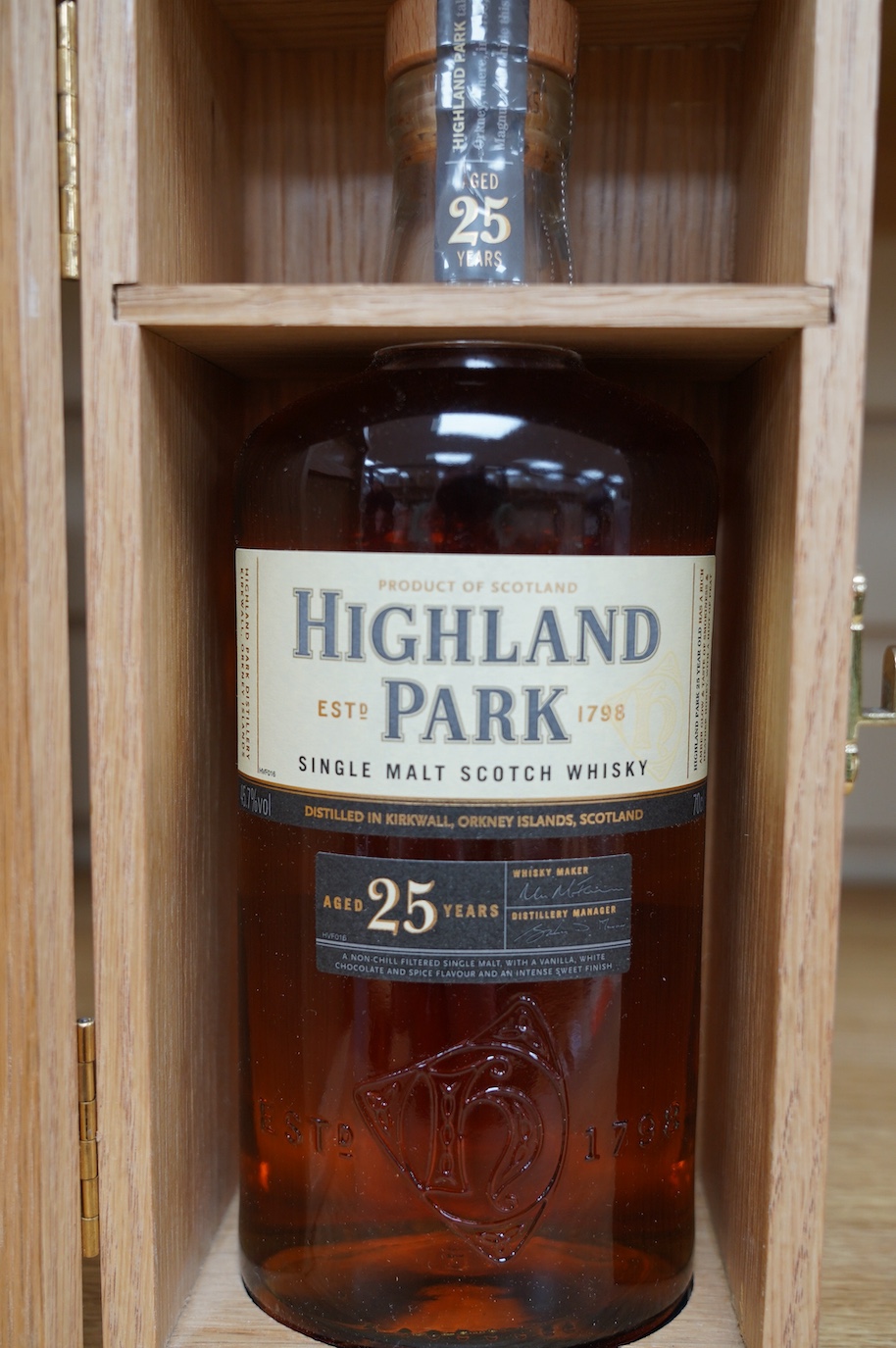 A wood cased bottle of Highland Park 25 year old whisky. Condition - good